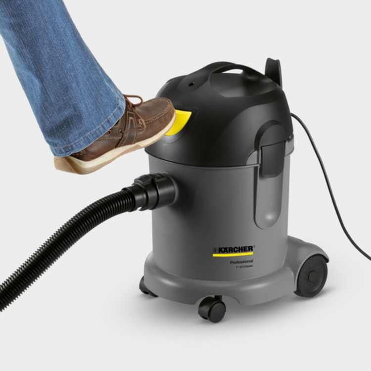 Karcher vacuum cleaner with a person's foot stepping on it, on a light gray background