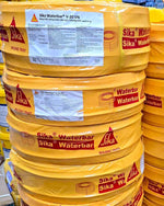 Stack of yellow Sika Waterbar V-20 VN buckets with visible branding.