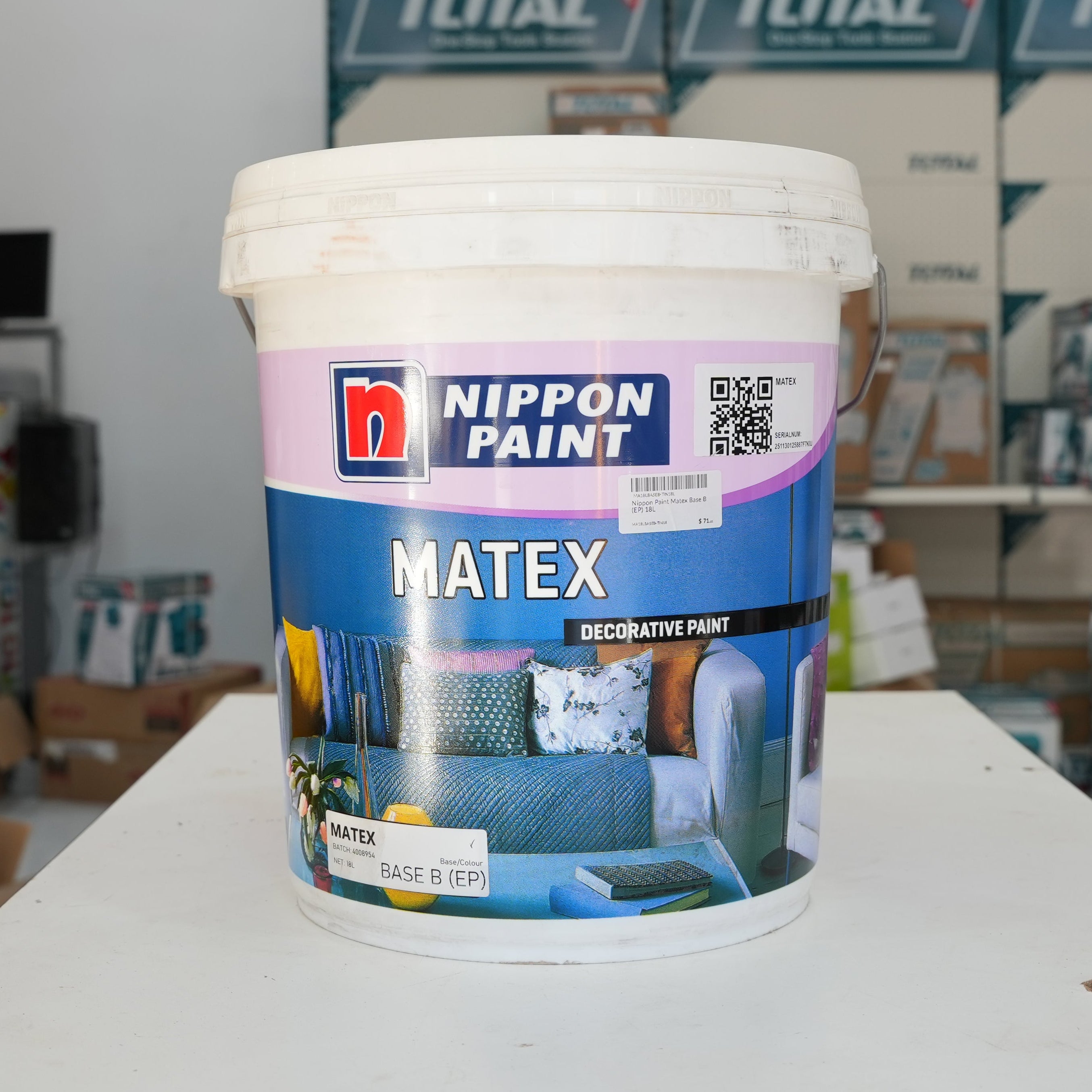 Nippon Paint Matex decorative paint bucket on a table with blurred background