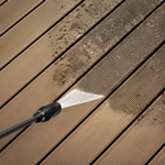 High-pressure water cleaning a wooden deck