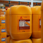 Yellow SikaLatex containers stacked in a warehouse setting