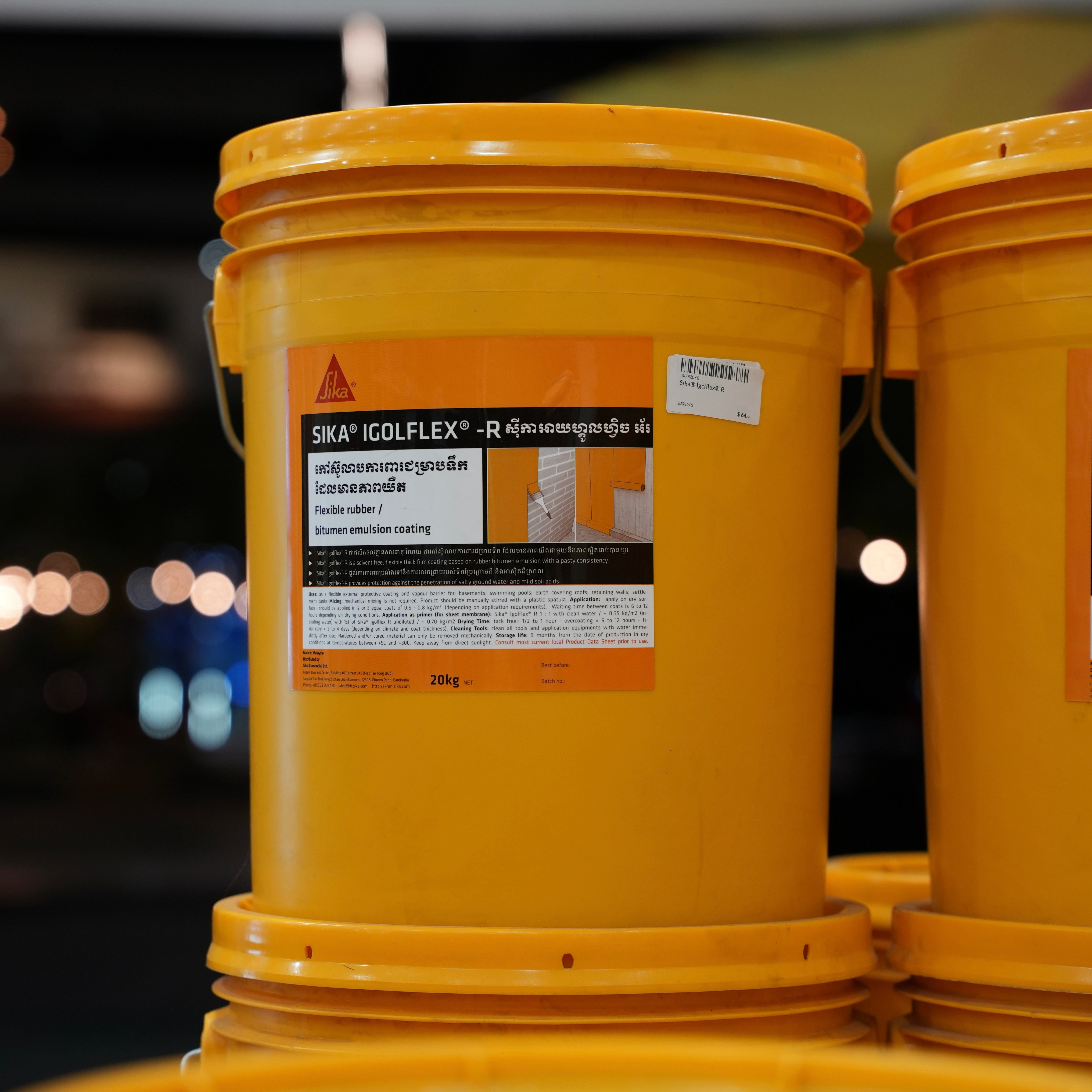 Yellow buckets with Sika Igolflex label on a blurred background