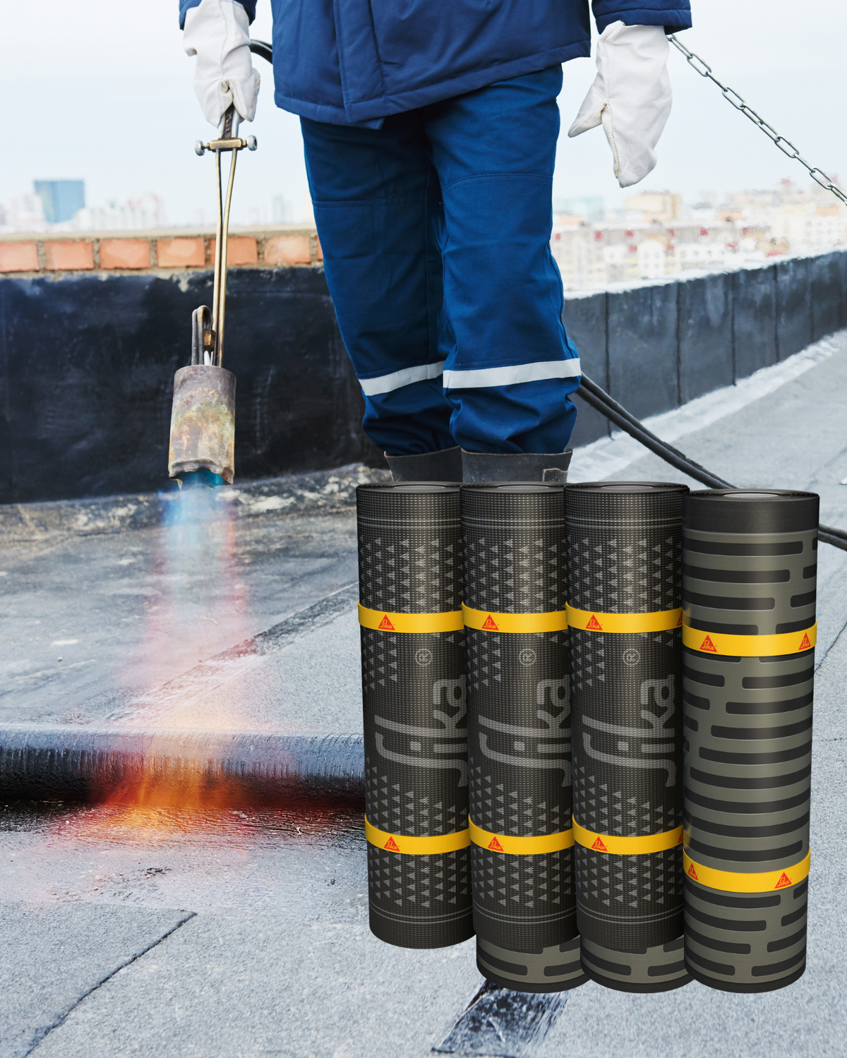 Person working on a roof with rolls of Sika roofing material.