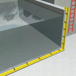 Insulation of a wall with yellow insulation material and a red ladder in the background.