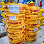 Stacks of yellow Sika Waterbar barrels in a warehouse setting.